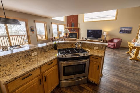 View from the Kitchen to Great Room and deck with great views of the mountains.