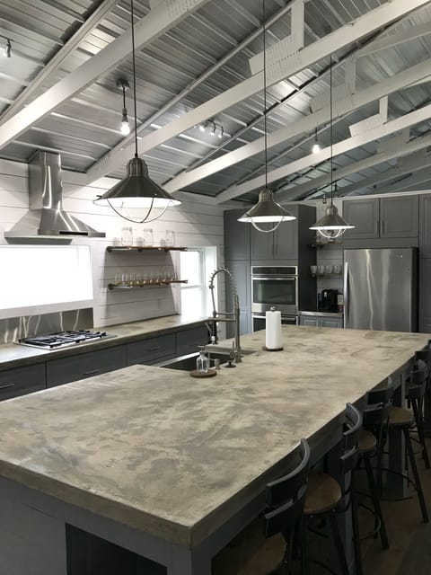 Large concrete island seats six. Coffee bar located between fridge and ovens.