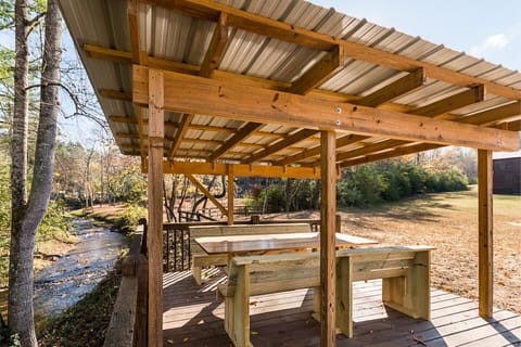 Sit under gazebo near firepit while eating your meal and listen to rushing creek