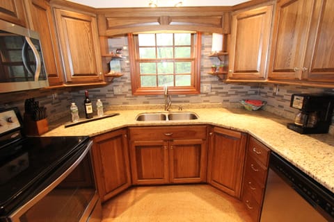 A Very Modern Kitchen with stove, microwave, dishwasher and huge refrigerator.
