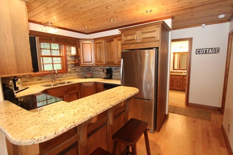 Breakfast counter and kitchen with bar stools to enjoy that glass of wine at.