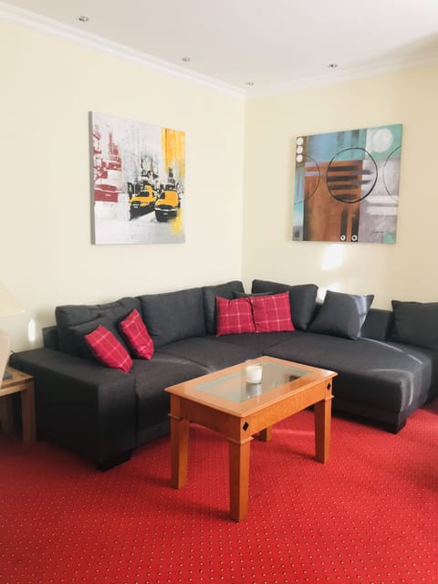 Deluxe Suite | Living area | 22-inch flat-screen TV with satellite channels, TV