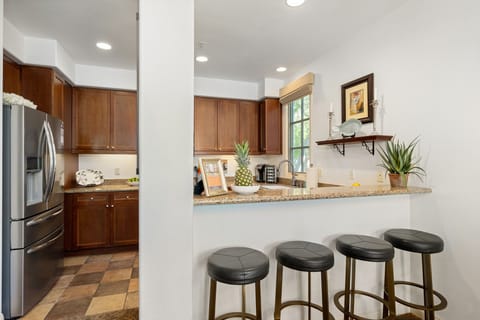 Stylish kitchen with granite countertops and a cozy breakfast bar—seating for 4