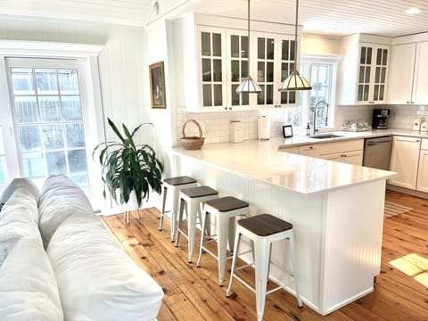 Kitchen features quartz countertops/ stainless appliances including a bev fridge