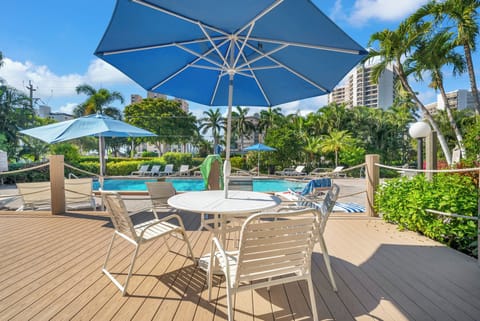 Lounge Chairs, tables and umbrellas around pool area