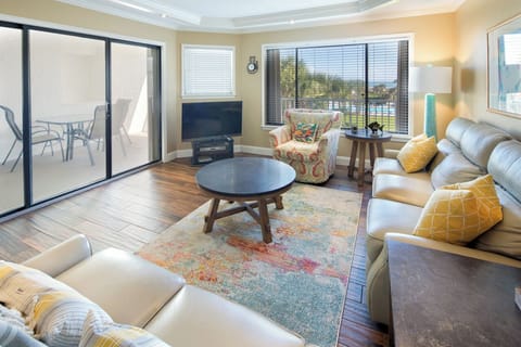 Living Room - View to Balcony - Spacious living room with open floor plan and connected balcony featuring a direct view of the ocean.