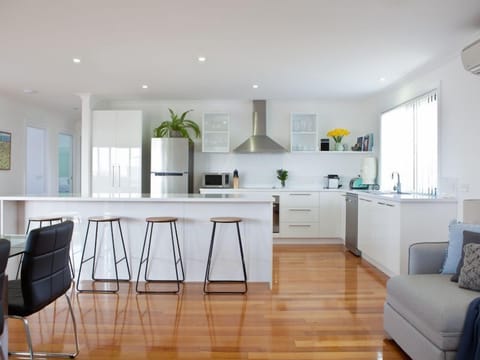 The upstairs kitchen is modern, fully equipped and beautifully bright