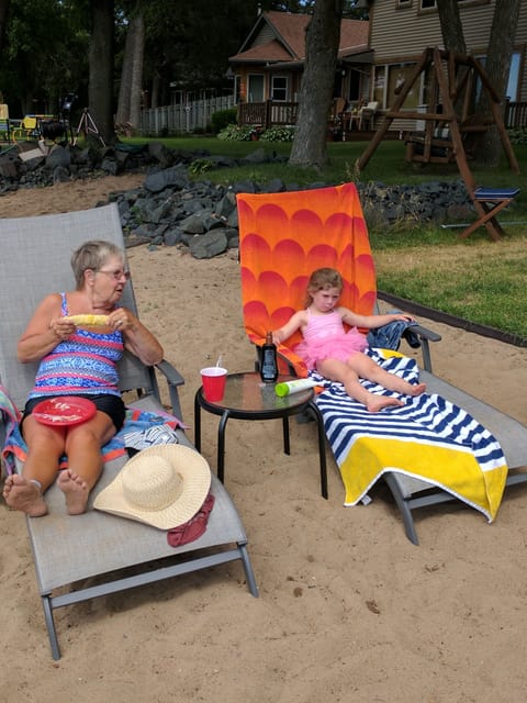great-grandmother and great-granddaughter sharing memories on the beach!