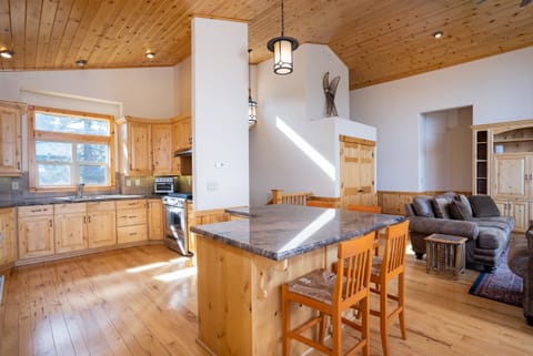 Step into the well-equipped kitchen that offers granite countertop and beautiful pine cabinetry, stainless steel appliances including a large french door refrigerator with bottom freezer, 2 sinks and a breakfast bar with seating for 4.