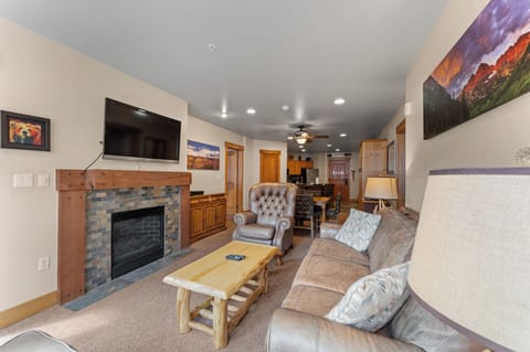 Cozy up by the fireplace while enjoying mountain views on the large TV in this comfortable living space.