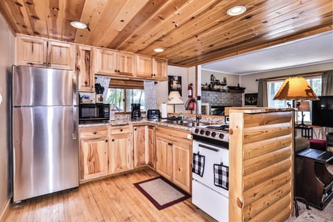 Rich wooden cabinetry & ceiling create rustic ambiance.