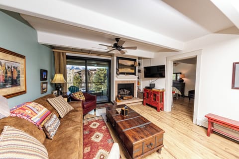 Living area with gas fireplace and balcony.