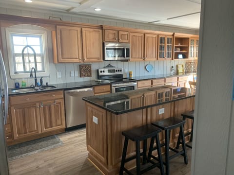 Fully stocked kitchen with seating at island for three