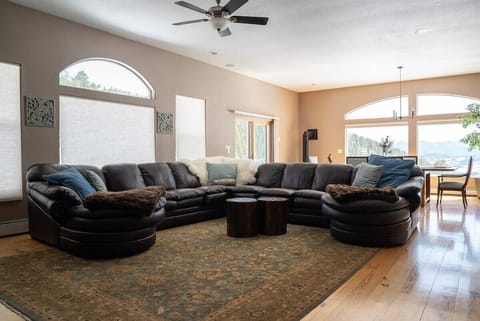 Our wonderfully spacious living room! Huge leather sofa & tons of natural light
