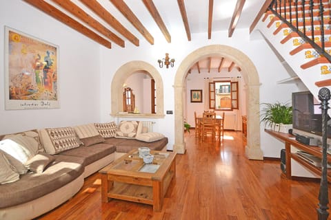 Convent's living-dining room in Alcúdia, Mallorca. Spacious and cozy area with wooden beams and rustic details.
