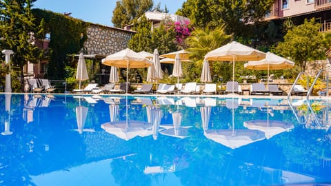 Seasonal outdoor pool, open 8:30 AM to 8:30 PM, pool umbrellas