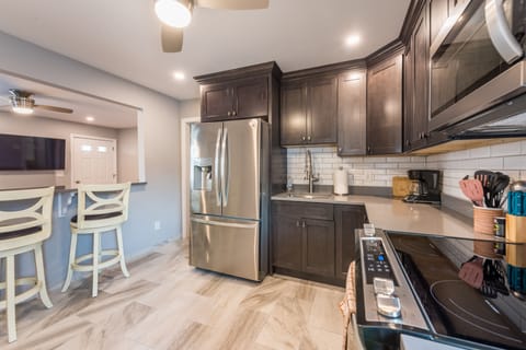 Brand new gourmet Kitchen with Quartz countertops and open access to Family room