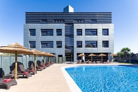 Seasonal outdoor pool, open 11:00 AM to 9:00 PM, pool umbrellas