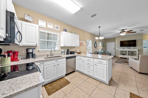 Your spacious kitchen features granite counters, modern appliances, and opens to the living area - perfect for preparing meals and staying connected.