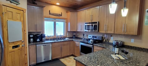 Large, fully stocked kitchen with 42" cabinets and granite counters.