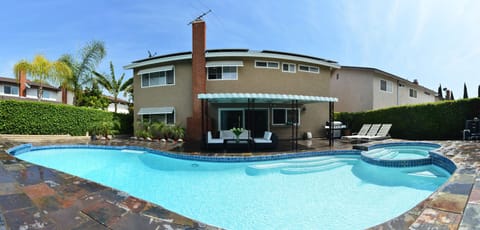Heated pool and spa in spacious back yard with patio and sitting area