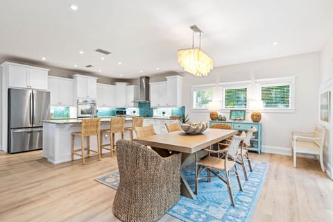 Open Dining & Kitchen Space Overlooking Pool Area with Sliding Glass Doors