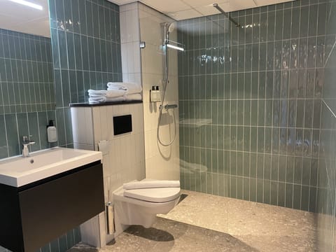 Shower, designer toiletries, hair dryer, towels