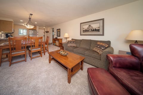 Settle into your cozy living space where warm wood furniture and plush seating create the perfect spot for family gatherings.