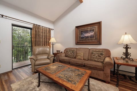 Relax in your cozy living room with plush leather seating and step out to your private balcony overlooking peaceful treetops.