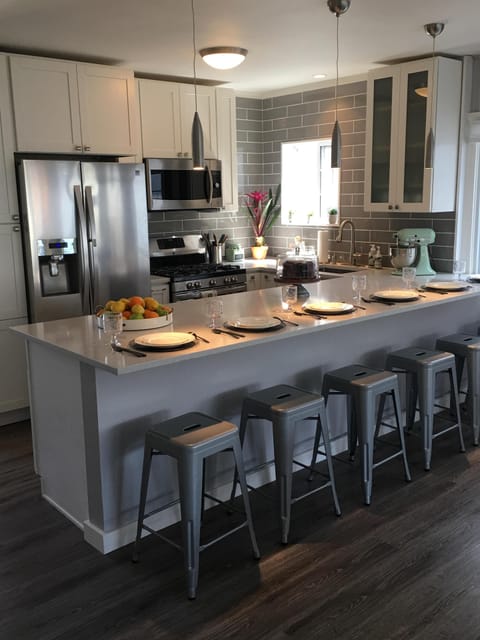 Extra large kitchen counter easily seats six.