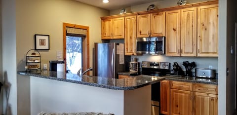 Well equipped kitchen with newer stainless steel appliances, save $ and dine in!