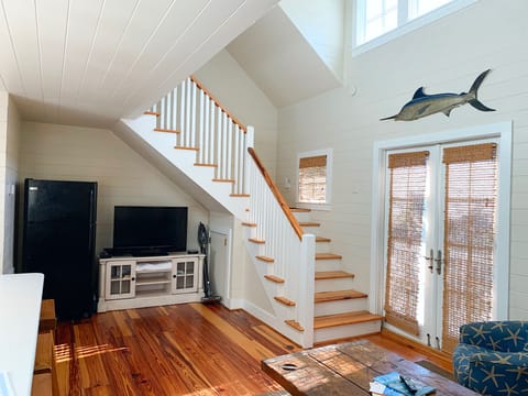 Stairs leading to large loft with queen bed, full bathroom and walk-in closet
