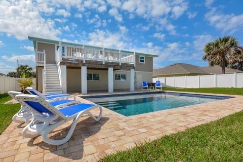 Back view of this home for rent new Smyrna beach with large pool and fenced in backyard.
