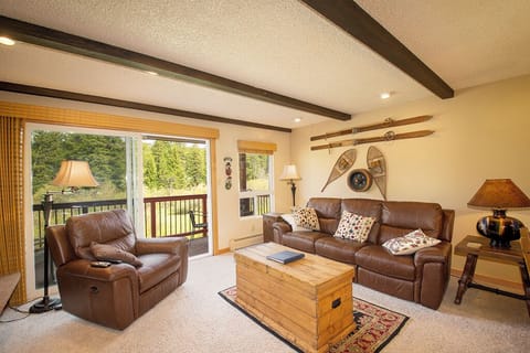 Sink into plush leather seating while enjoying forest views from your private deck in this cozy retreat.