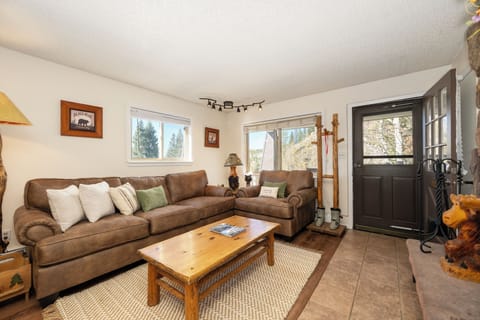 Sink into cozy leather sofas by your fireplace after mountain adventures. Rustic charm meets comfort in this welcoming living space.