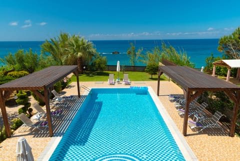 Outdoor pool, an infinity pool, pool umbrellas, sun loungers