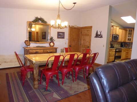View of large dining table with extra leaf. Doors to garage and lower level