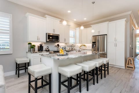 Well-equipped chef's kitchen with a large island and seating area.