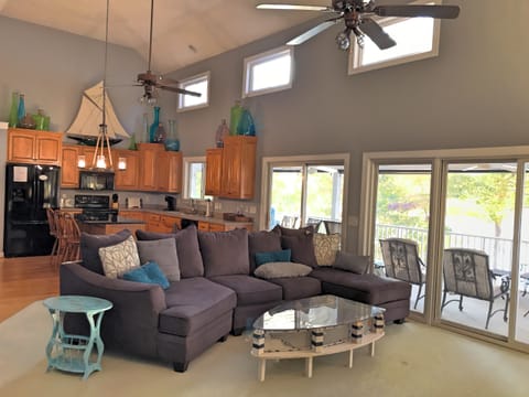 Open living area with doors to screened in porch and lake views.