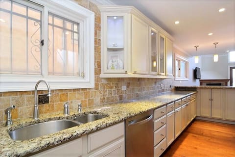 Kitchen is fully equipped with plates, silverware and other kitchenware