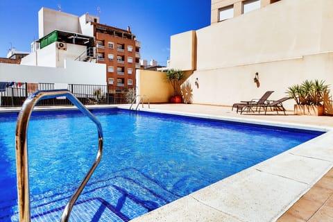 Outdoor pool, open 9 AM to 9 PM, pool umbrellas, sun loungers