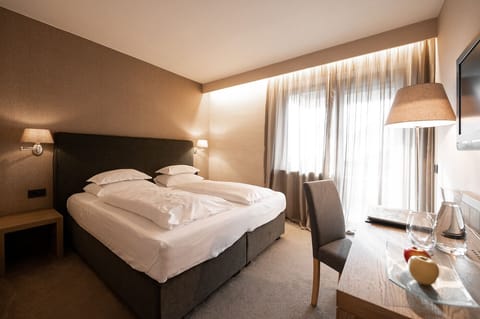 Economy Double Room | Minibar, in-room safe, desk, blackout drapes