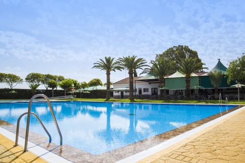 Seasonal outdoor pool, open 11:00 AM to 8:00 PM, pool umbrellas