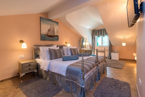 Standard Double Room | Minibar, in-room safe, individually decorated, blackout drapes