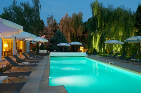 Seasonal outdoor pool, open 8:00 AM to 7:00 PM, pool umbrellas