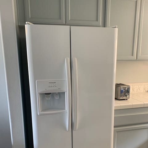 New fridge with ice and water on door.
