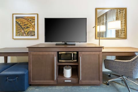 Premium bedding, desk, laptop workspace, blackout drapes