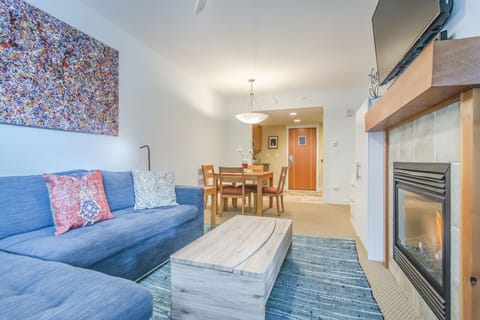 Living Area - Queen size sofa sleeper, gas fireplace, flat screen TV, and access to private balcony.
