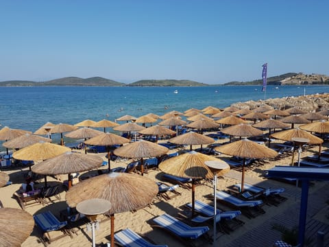 On the beach, sun loungers, beach umbrellas, beach towels