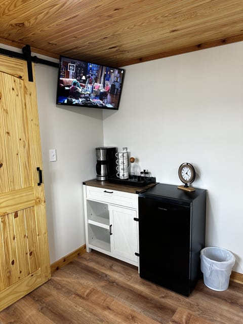 Lower bedroom coffee bar, private fridge, and smart TV.